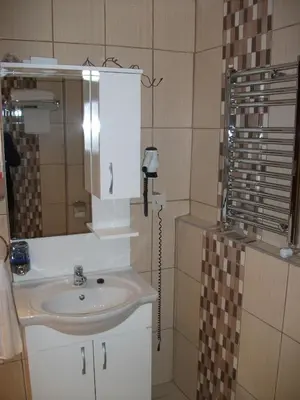 a bathroom with a sink and a mirror at Sultan Palace Hotel in Istanbul