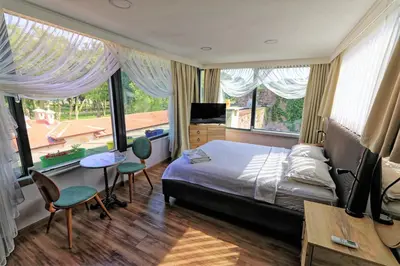 a bedroom with a bed and a table and chairs at Romantic Mansion in Istanbul