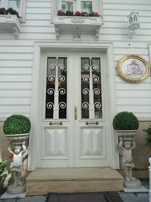 a front door of a house with twoiaries at Romantic Mansion in Istanbul