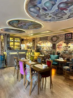 a restaurant with tables and chairs in a room at Romantic Mansion in Istanbul