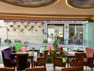 a restaurant with tables and chairs in front of a building at Romantic Mansion in Istanbul