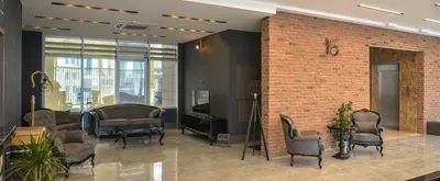 a lobby with chairs and a brick wall at A11 Hotel Atasehir in Istanbul