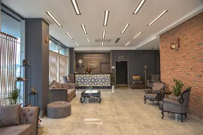 a lobby with couches and chairs and a brick wall at A11 Hotel Atasehir in Istanbul