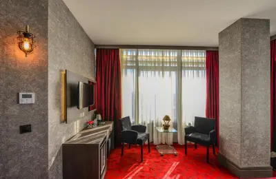 a hotel room with two chairs and a table and a television at A11 Hotel Atasehir in Istanbul