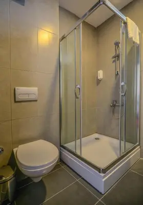 a bathroom with a toilet and a glass shower at A11 Hotel Atasehir in Istanbul