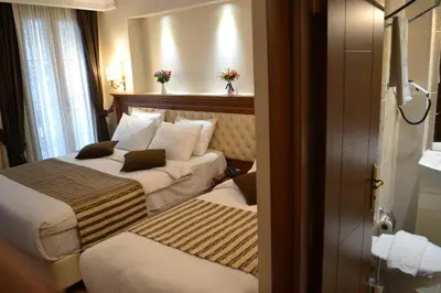 a hotel room with two beds and a window at Seven Days Hotel - İstanbul in Istanbul