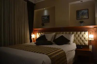 a hotel room with a large bed with two pillows at Seven Days Hotel - İstanbul in Istanbul