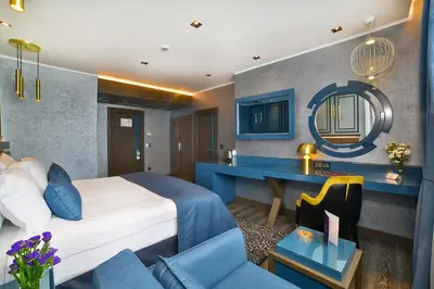 a hotel room with a bed and a mirror at Amethyst Hotel in Istanbul