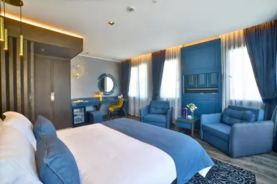 a bedroom with a large bed and blue furniture at Amethyst Hotel in Istanbul