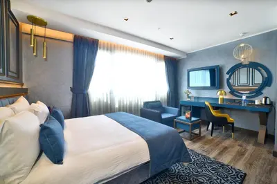 a hotel room with a bed and a desk at Amethyst Hotel in Istanbul