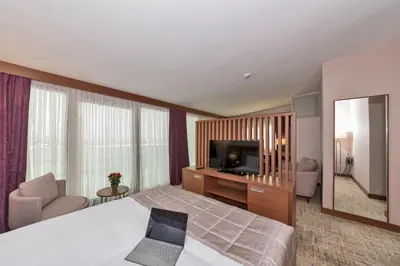 a hotel room with a laptop on a bed at Land Park Hotel in Istanbul