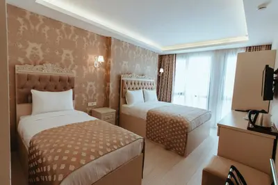 a hotel room with two beds and a television at Istanroom by Keo in Istanbul