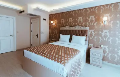 a bedroom with a bed with a brown and white bedspread at Istanroom by Keo in Istanbul