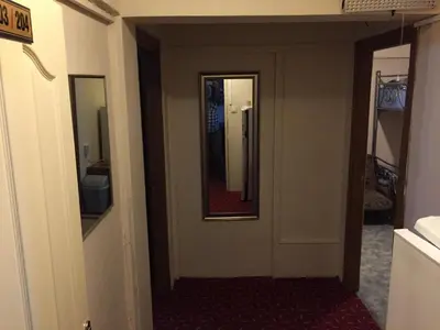 a hallway of a hotel room with a mirror at Paris Hotel in Istanbul