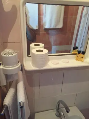 a bathroom with two rolls of toilet paper on a shelf at Paris Hotel in Istanbul