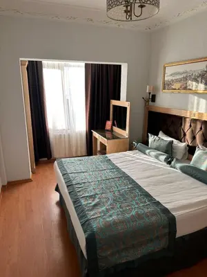 a bedroom with a large bed and a large window at Blue Tuana Hotel Old City in Istanbul