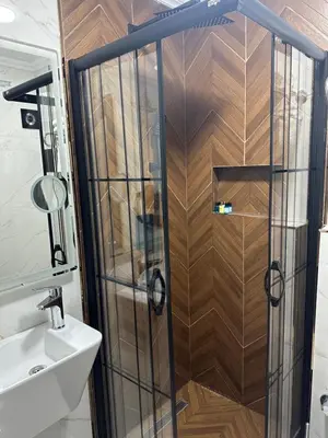 a shower with a glass door next to a sink at Blue Tuana Hotel Old City in Istanbul
