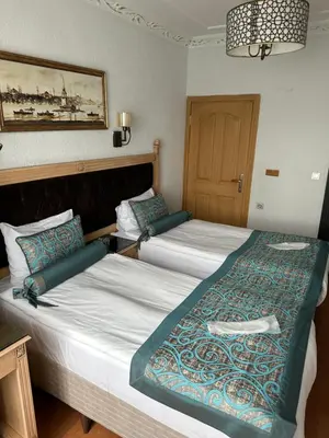 two beds in a hotel room with at Blue Tuana Hotel Old City in Istanbul