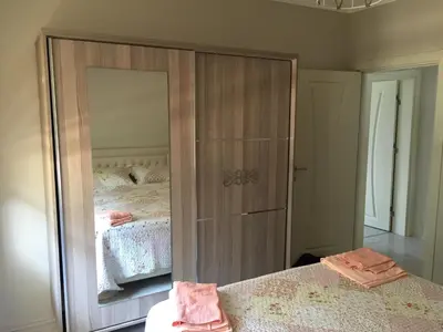 a bedroom with a large mirror next to a bed at Yıldız Pansiyon in Sapanca