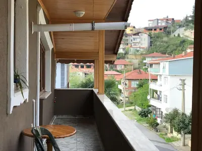 a balcony with a table and a view of a city at Yıldız Pansiyon in Sapanca