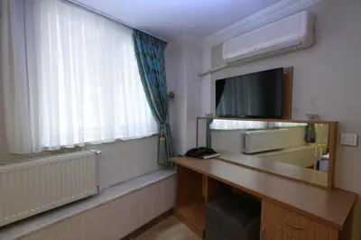 a room with a desk with a television and a window at Agora Boutique Hotel & Bistro in Istanbul