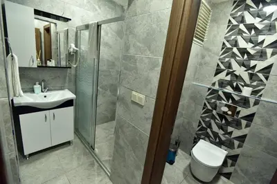 a bathroom with a shower and a toilet and a sink at Rays Hotel - Bakirkoy Istanbul City Center in Istanbul