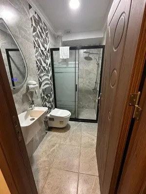 a bathroom with a shower and a toilet and a sink at Rays Hotel - Bakirkoy Istanbul City Center in Istanbul