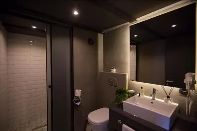 a bathroom with a sink and a toilet and a mirror at Cityloft 161 in Istanbul