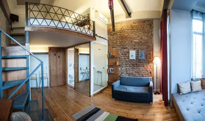 a living room with a staircase and a couch at Peradays in Istanbul