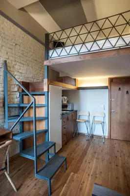 a room with a bunk bed and a kitchen at Peradays in Istanbul