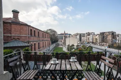 a table on a balcony with a view of a city at Peradays in Istanbul