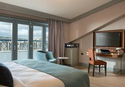 a hotel room with a bed and a flat screen tv at Millennium Istanbul Golden Horn in Istanbul