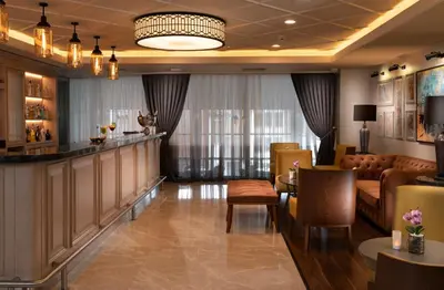 a hotel lobby with a bar and a dining room at Millennium Istanbul Golden Horn in Istanbul