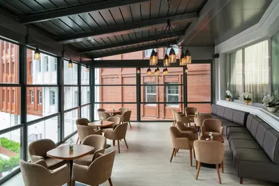 a restaurant with tables and chairs and windows at Millennium Istanbul Golden Horn in Istanbul