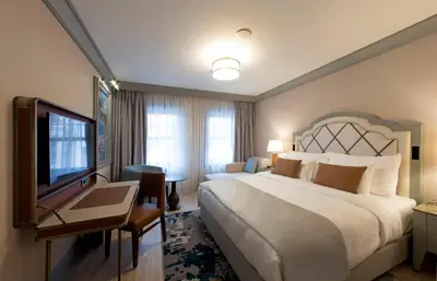 a hotel room with a large bed and a television at Millennium Istanbul Golden Horn in Istanbul