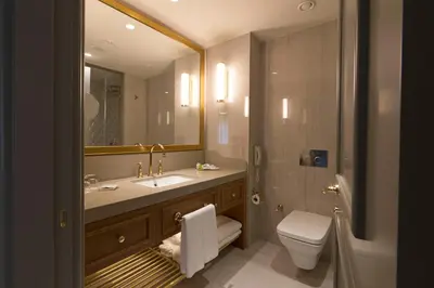 a bathroom with a sink and a toilet and a mirror at Millennium Istanbul Golden Horn in Istanbul