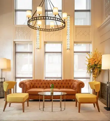 a living room with a couch and a table and chairs at Millennium Istanbul Golden Horn in Istanbul
