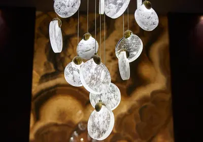 a bunch of white glass ornaments hanging from a ceiling at Dundar Hotel & Spa in Istanbul