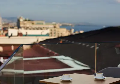 two cups of coffee sitting on a table on a balcony at Dundar Hotel & Spa in Istanbul