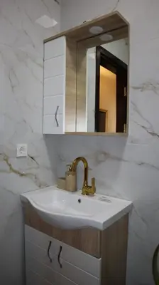 a bathroom with a sink and a mirror at Blue Eye Suites in Istanbul