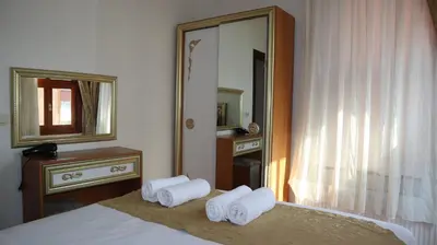 a bedroom with a bed and a mirror and towels at Blue Eye Suites in Istanbul