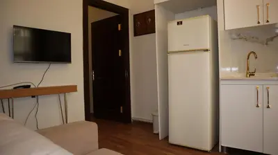 a kitchen with a white refrigerator in a room at Blue Eye Suites in Istanbul