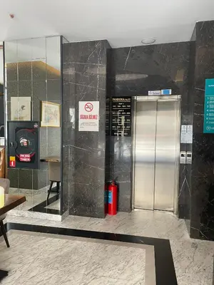 a metal elevator in a building with a sign on the wall at Pandora Hotel in Istanbul