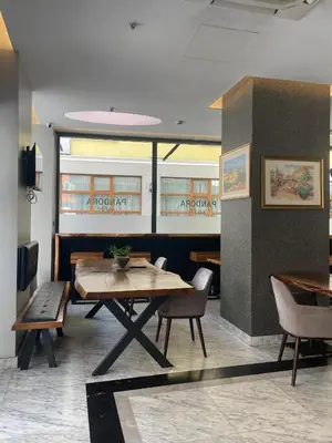a dining room with a wooden table and chairs at Pandora Hotel in Istanbul