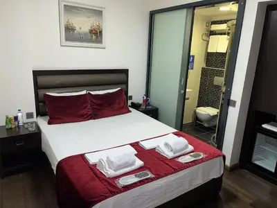 a bedroom with a large bed with towels on it at Pandora Hotel in Istanbul