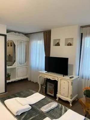 a living room with a tv on top of a fireplace at Pandora Hotel in Istanbul