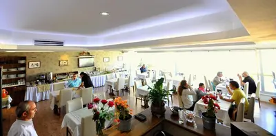 a group of people sitting in a restaurant at Khalkedon Hotel Istanbul in Istanbul