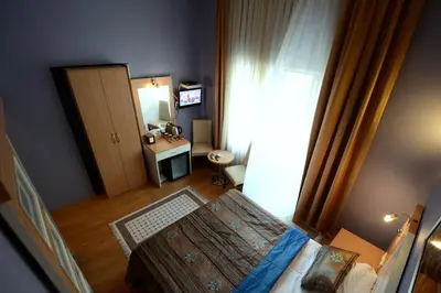 a room with a bedroom with a bed and a mirror at Khalkedon Hotel Istanbul in Istanbul