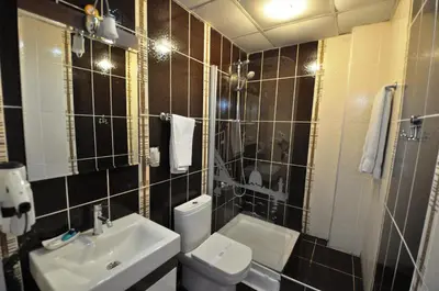 a bathroom with a toilet and a sink at Khalkedon Hotel Istanbul in Istanbul