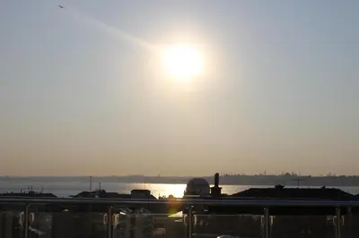 a view of the sun setting over the water at Khalkedon Hotel Istanbul in Istanbul